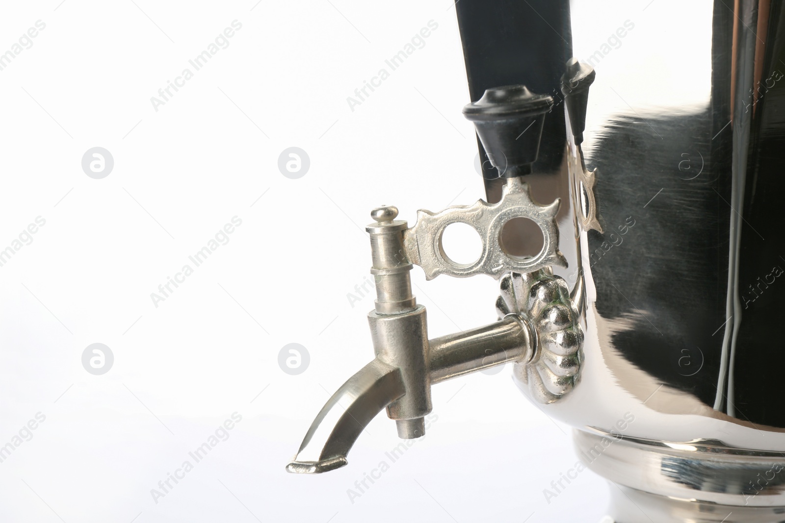 Photo of Closeup view of traditional Russian samovar on white background. Faucet detail