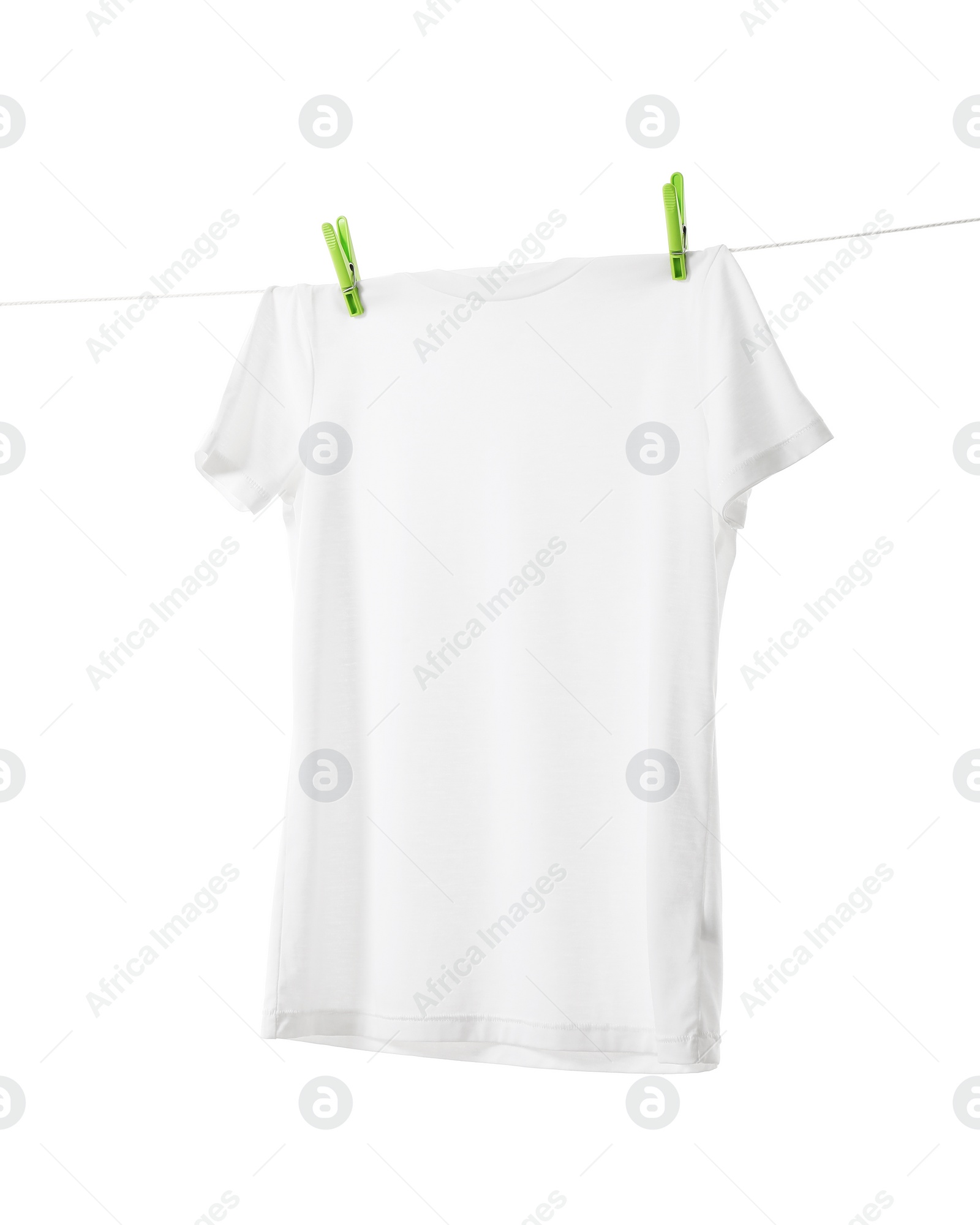 Photo of One t-shirt drying on washing line isolated on white
