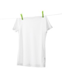 One t-shirt drying on washing line isolated on white