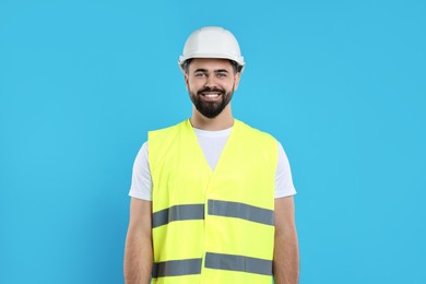 Engineer in hard hat on light blue background