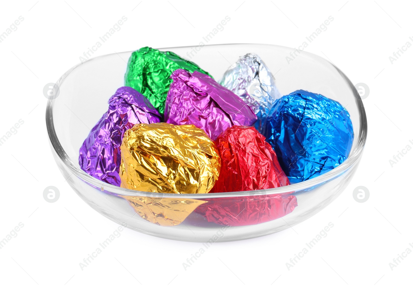 Photo of Bowl with many tasty candies in colorful wrappers isolated on white