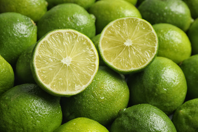 Fresh ripe juicy limes as background, closeup