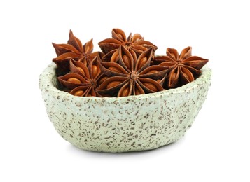 Photo of Bowl with dry anise stars on white background