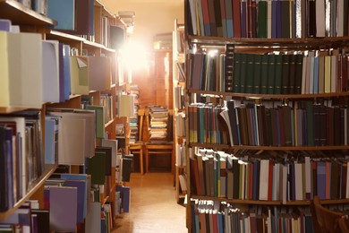 Collection of different books on shelves in library