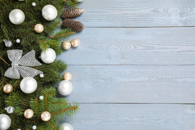 Photo of Fir branches with Christmas decoration on grey wooden background, flat lay. Space for text
