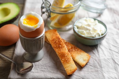 Soft boiled egg served for breakfast on wooden table