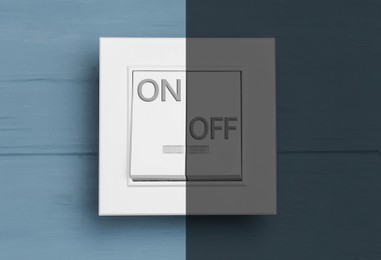 Turned ON and OFF light switch on blue wooden background