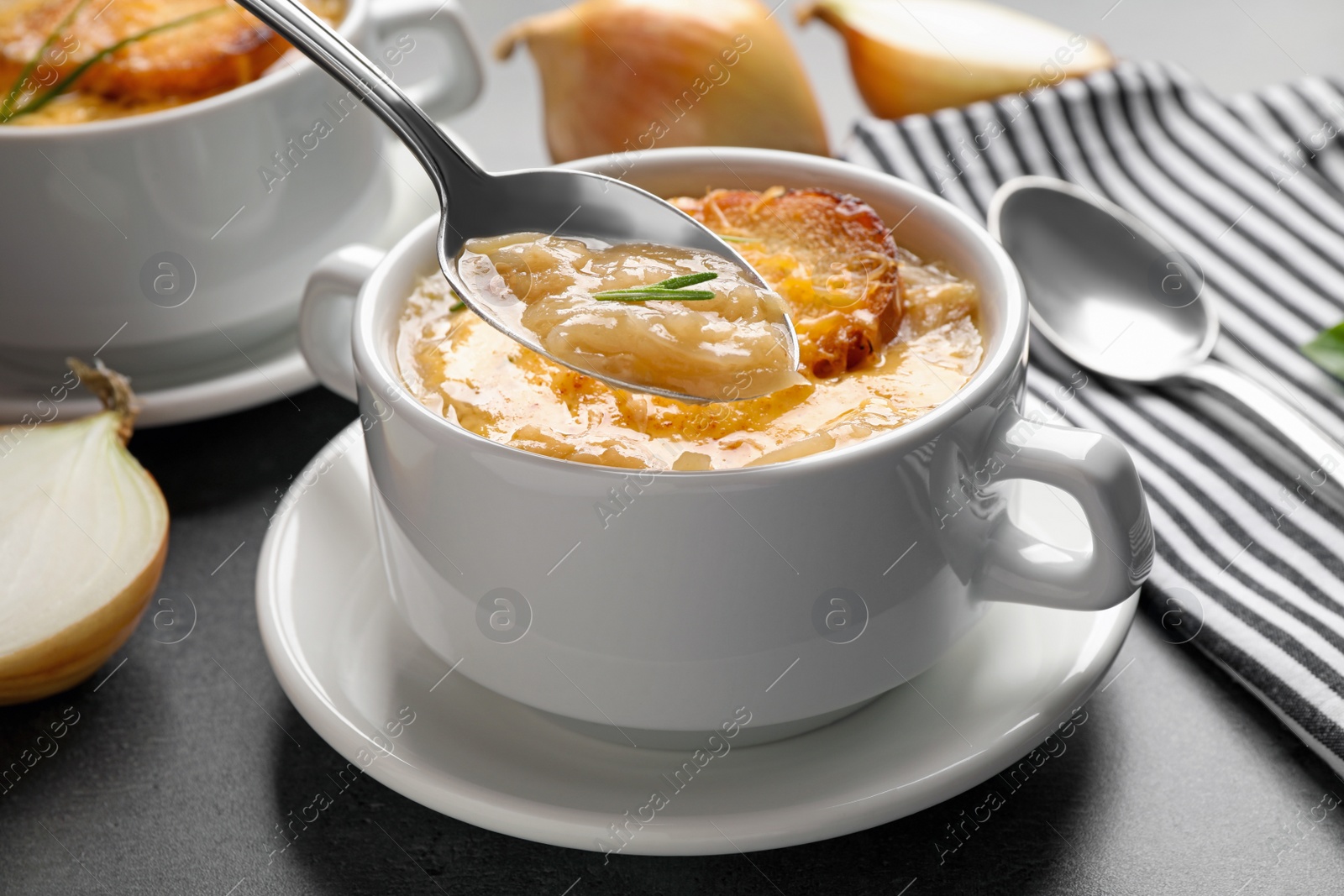 Photo of Fresh homemade french onion soup on grey table