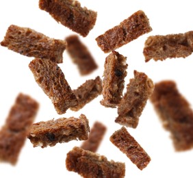 Image of Tasty rye croutons falling on white background, collage design