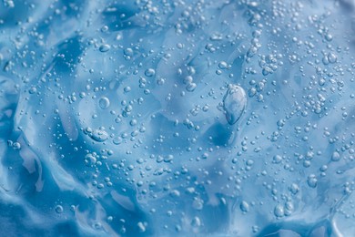 Photo of Texture of light blue shower gel as background, closeup