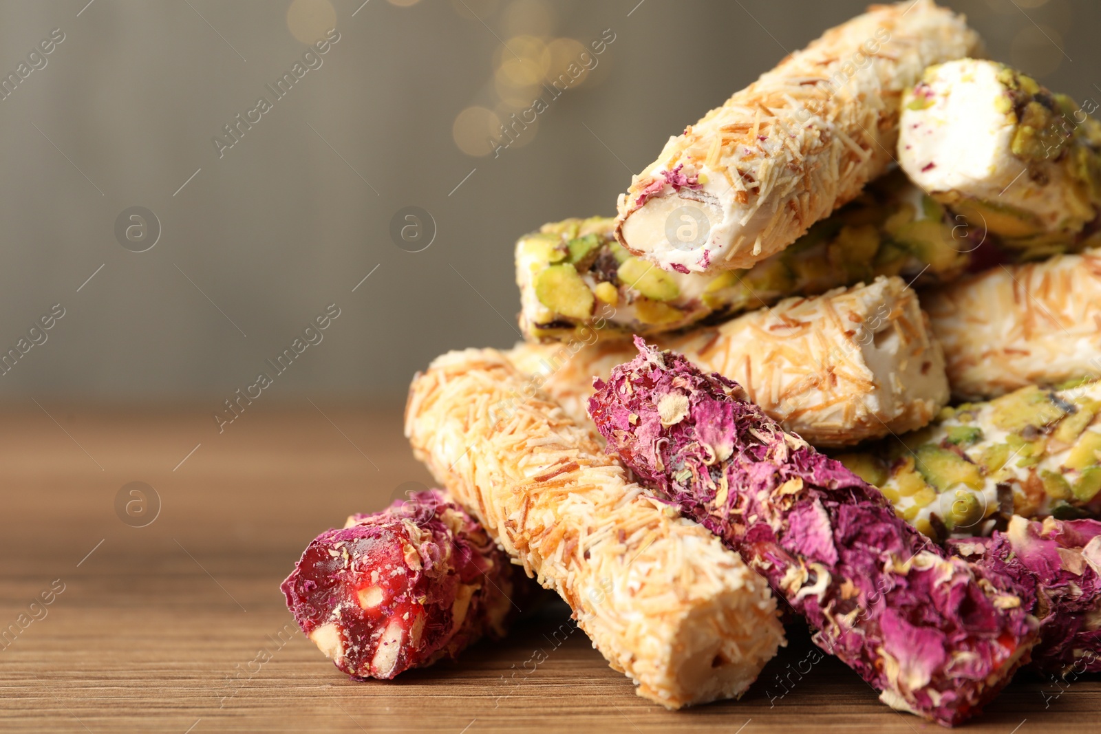 Photo of Turkish delight dessert on wooden table, closeup. Space for text