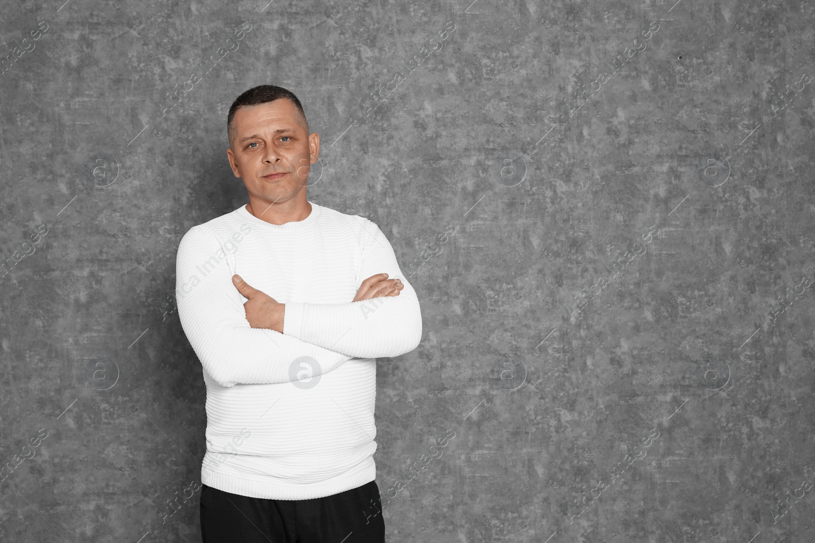 Photo of Portrait of mature man on grey background. Space for text