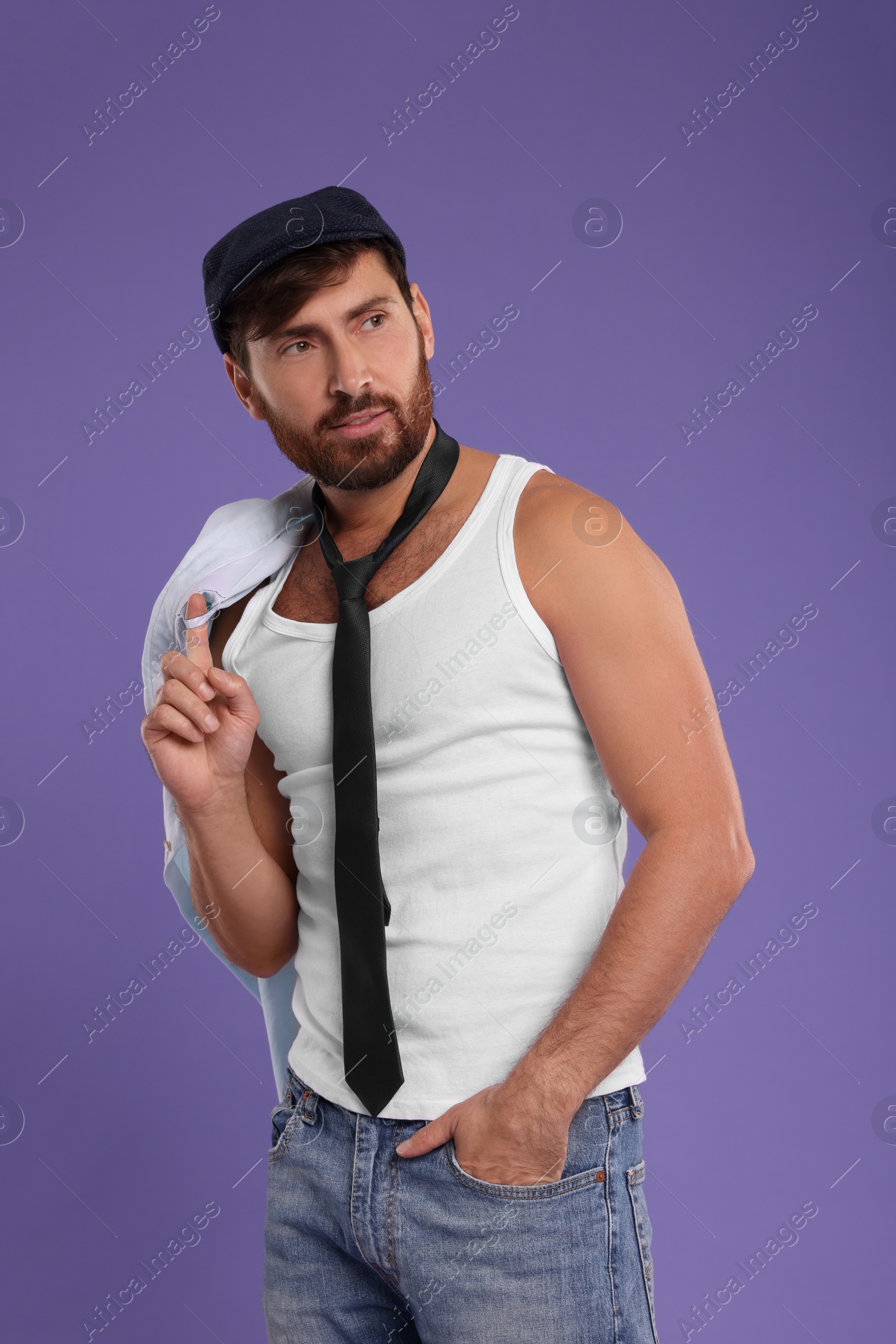 Photo of Attractive man with tie posing on violet background