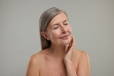 Photo of Beautiful woman with healthy skin on grey background