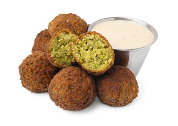 Photo of Delicious falafel balls and sauce isolated on white