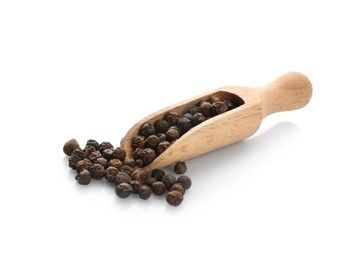 Wooden scoop with black pepper grains on white background