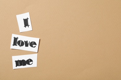 Photo of Phrase I Love Me made of paper pieces on beige background, flat lay. Space for text