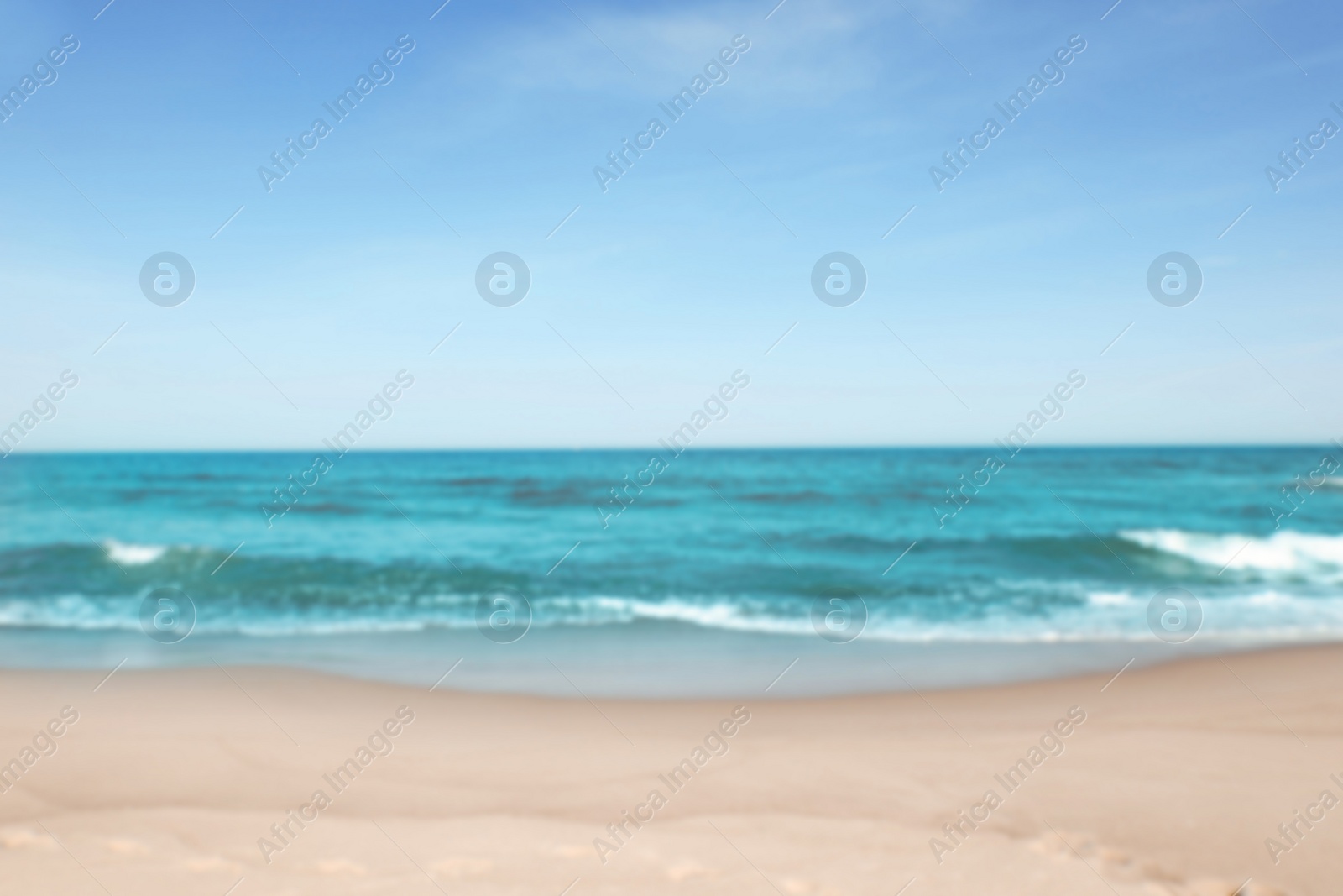 Photo of Blurred view of beautiful sea and sandy beach on sunny day