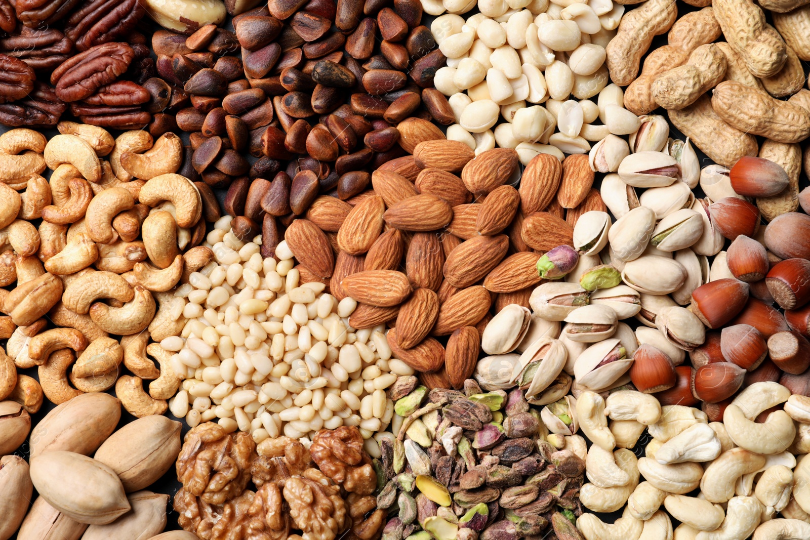 Photo of Organic mixed nuts as background, top view