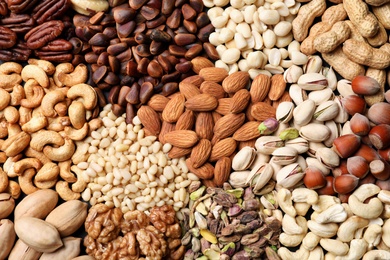 Photo of Organic mixed nuts as background, top view