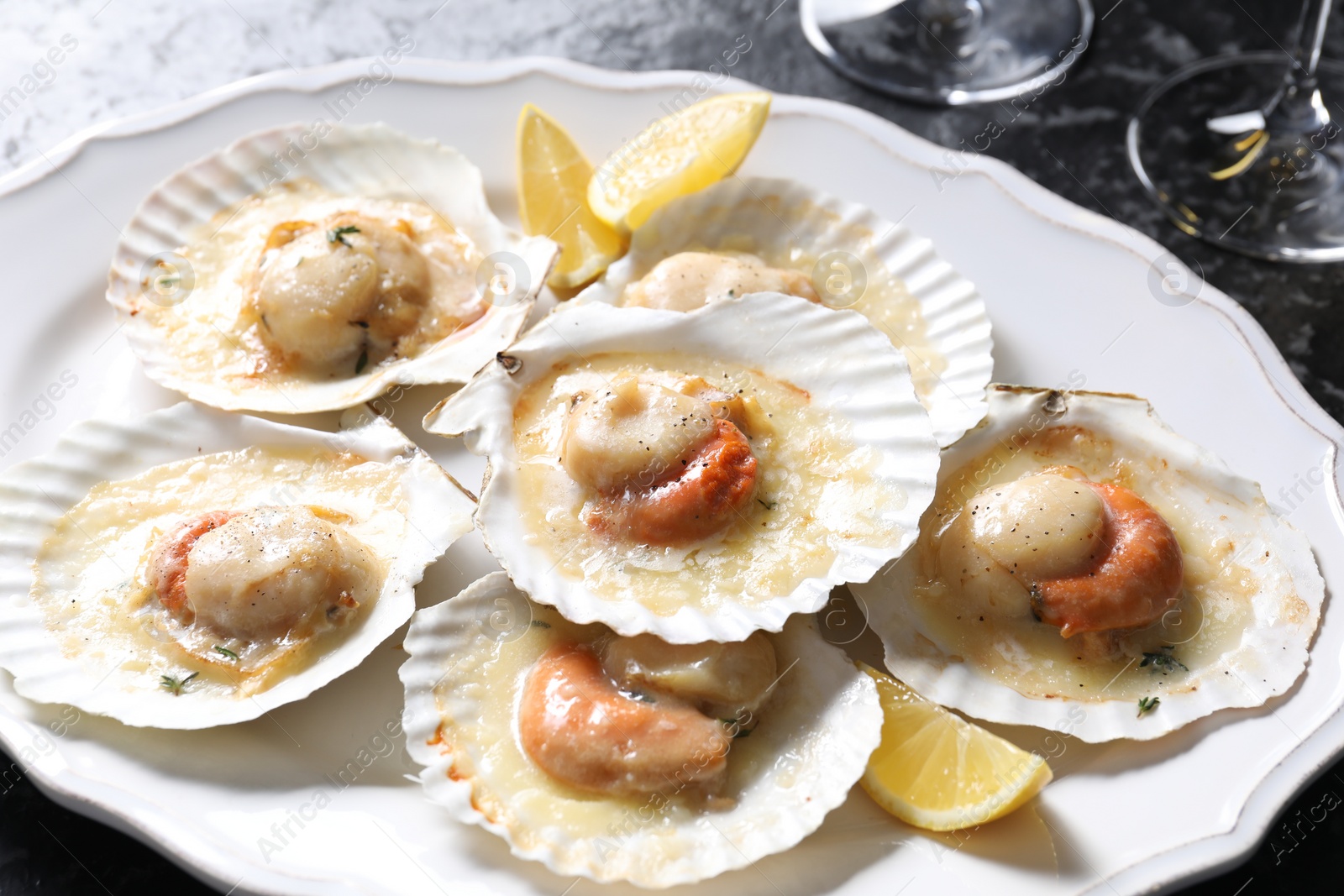 Photo of Fried scallops in shells on table, closeup