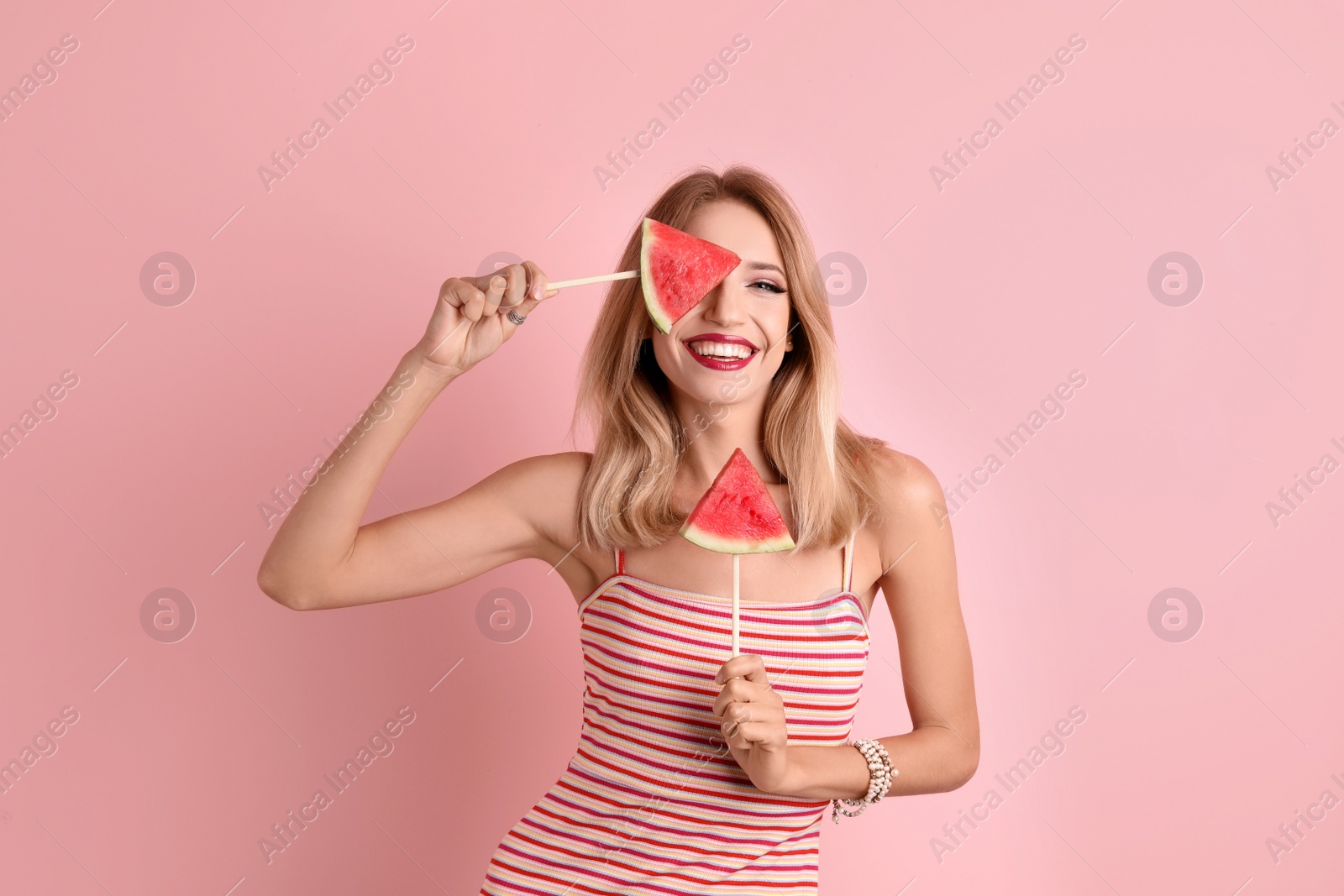 Photo of Pretty young woman with juicy watermelon on color background