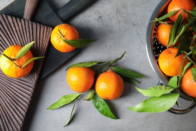 Photo of Flat lay composition with ripe tangerines on grey background