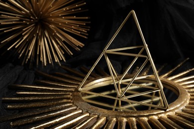 Photo of Different golden decor elements on black background