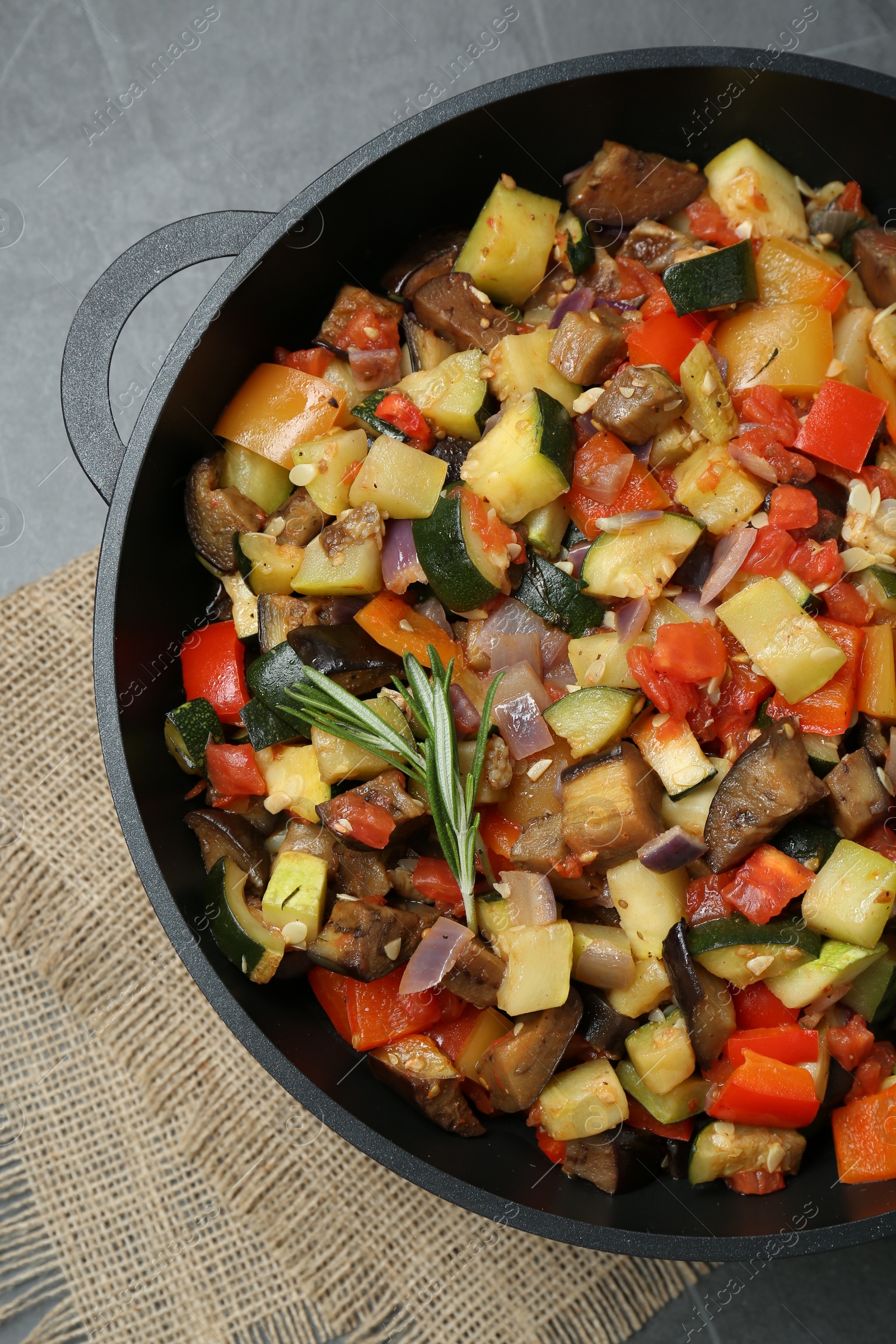 Photo of Delicious ratatouille in baking dish on grey table, top view