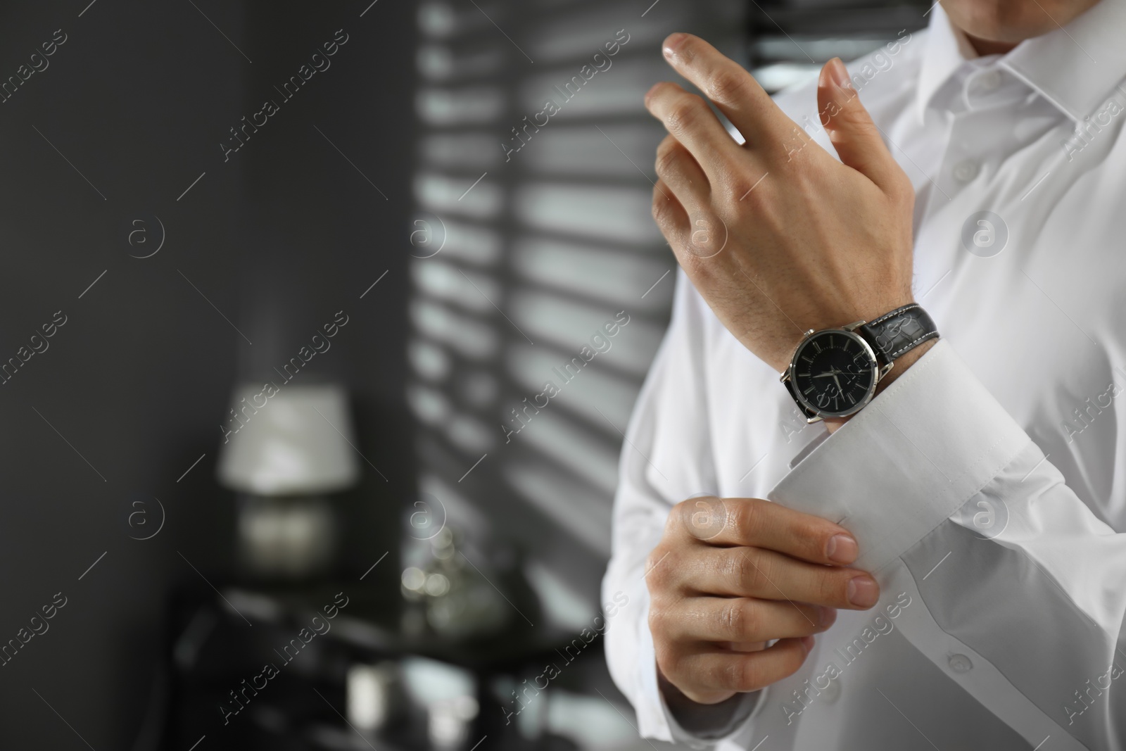 Photo of Man with luxury wrist watch indoors, closeup. Space for text