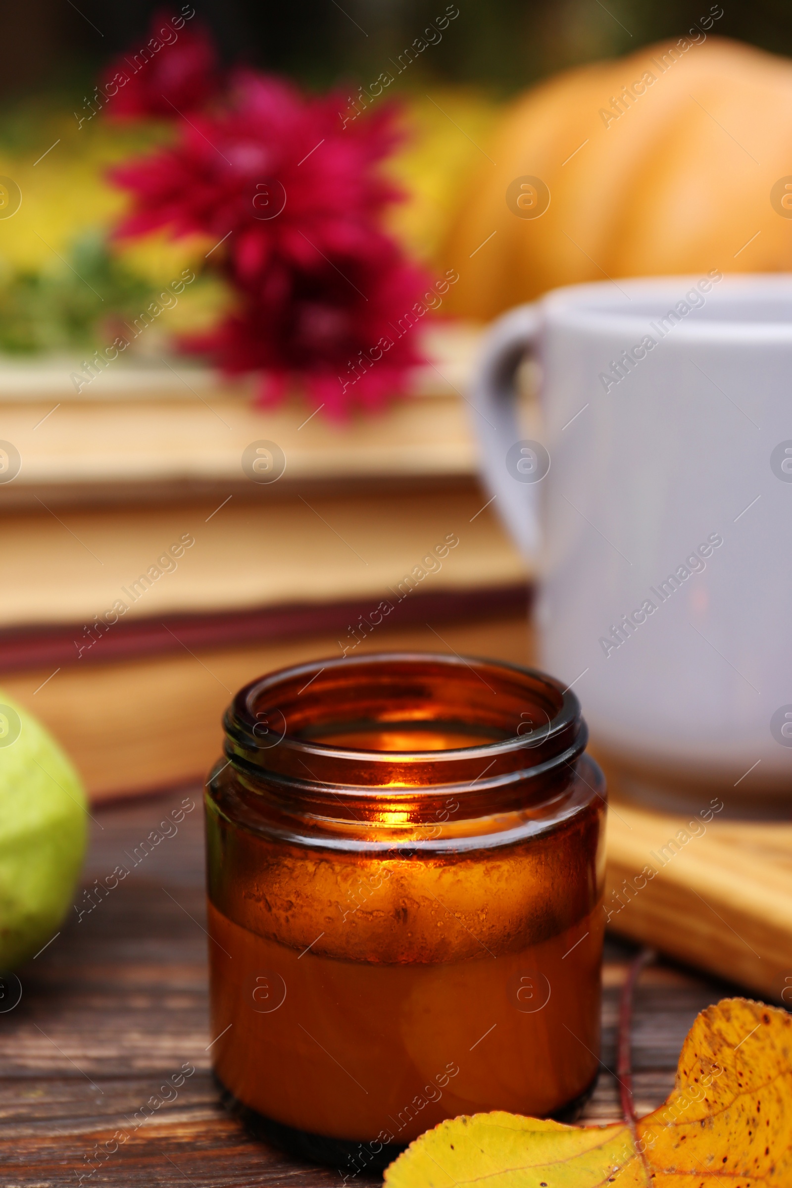Photo of Composition with burning candle on wooden table. Autumn atmosphere