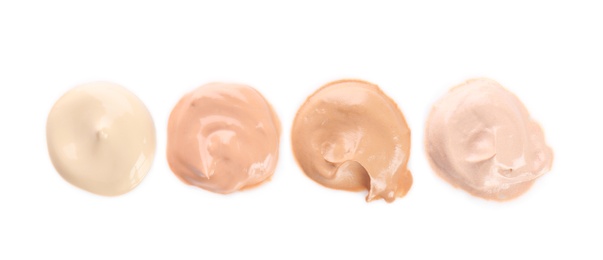 Different shades of liquid foundation on white background. Professional makeup products