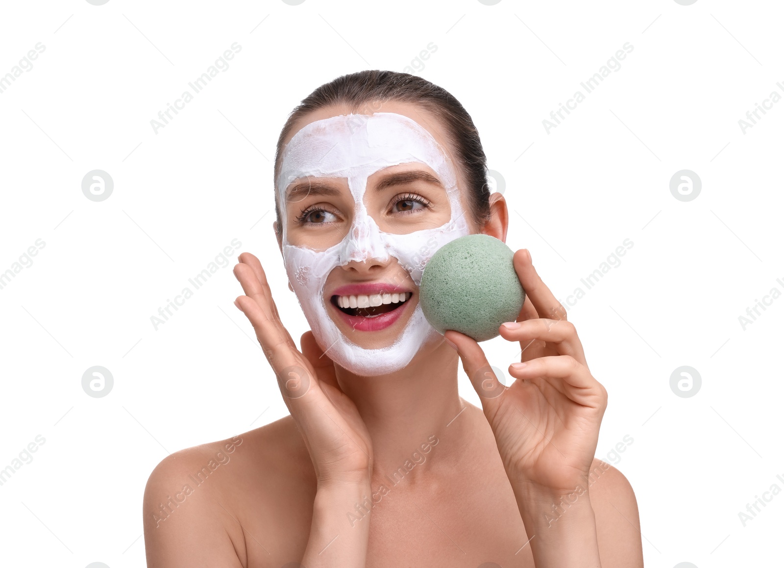 Photo of Happy young woman with face mask and sponge on white background