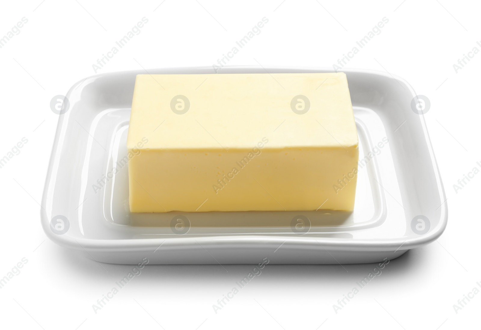 Photo of Ceramic dish with block of fresh butter on white background