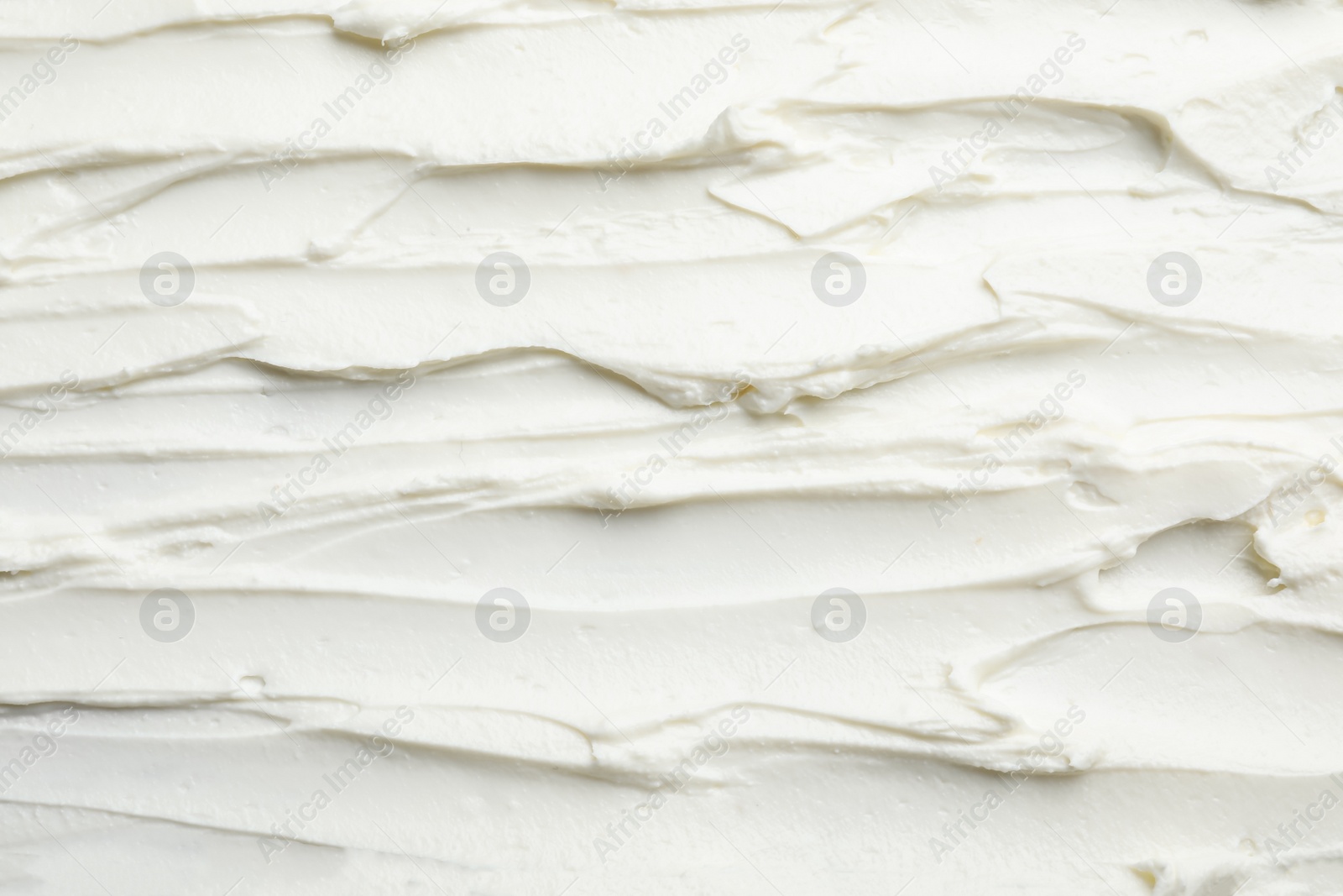 Photo of Closeup of tasty cream cheese as background, top view