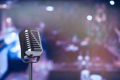 Image of Vintage microphone in karaoke club. Space for text