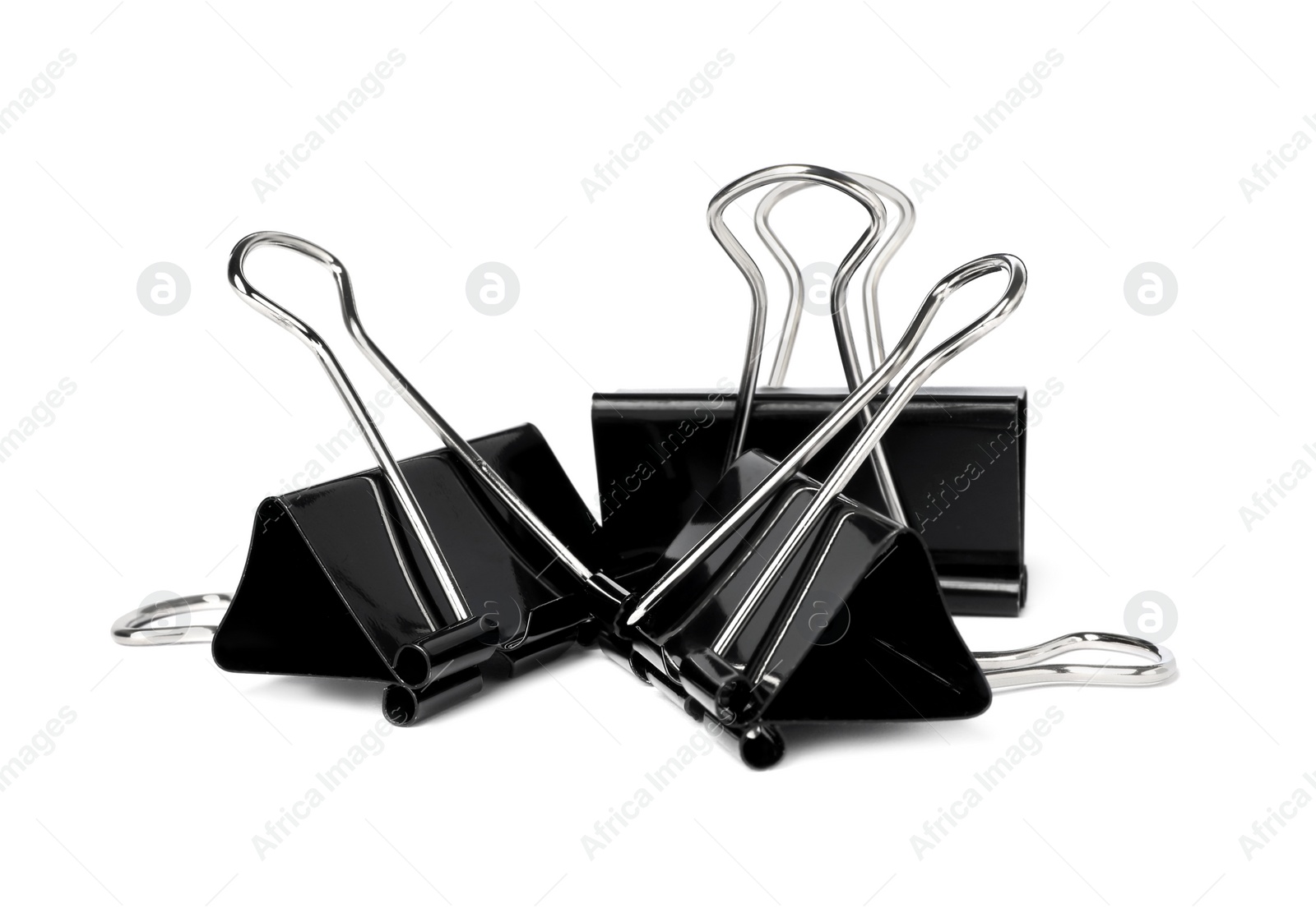 Photo of Black binder clips on white background. Stationery