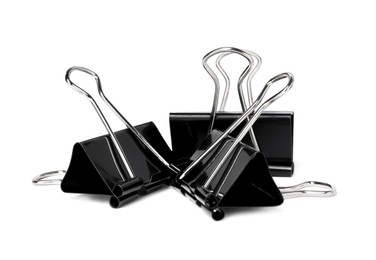 Photo of Black binder clips on white background. Stationery