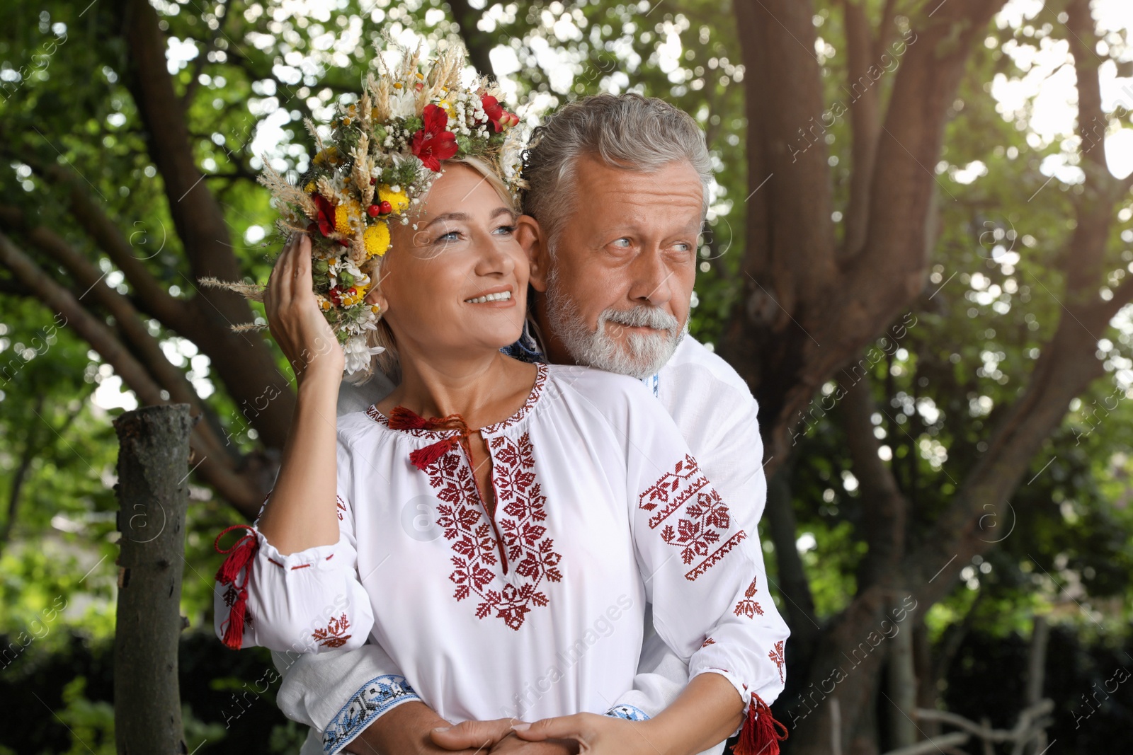 Photo of Happy mature couple in Ukrainian national clothes outdoors