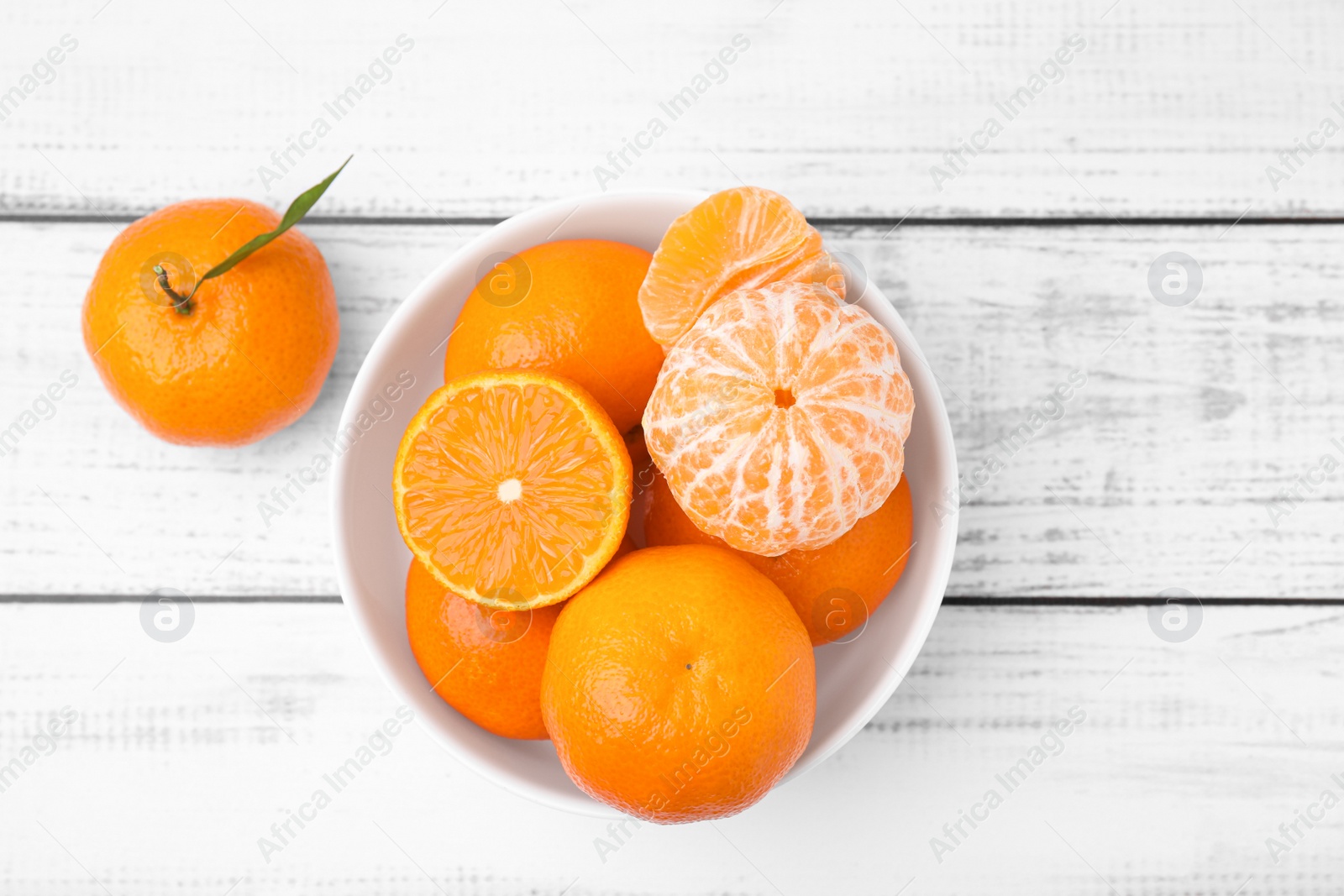 Photo of Fresh juicy tangerines on white wooden table, flat lay