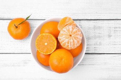 Photo of Fresh juicy tangerines on white wooden table, flat lay