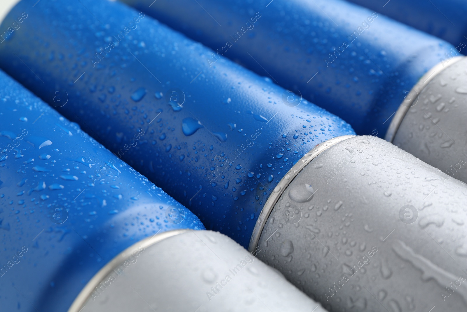 Photo of Energy drinks in wet cans as background, closeup