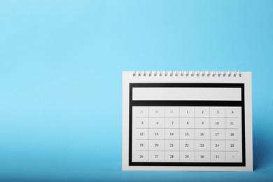Paper calendar on light blue background, space for text. Planning concept