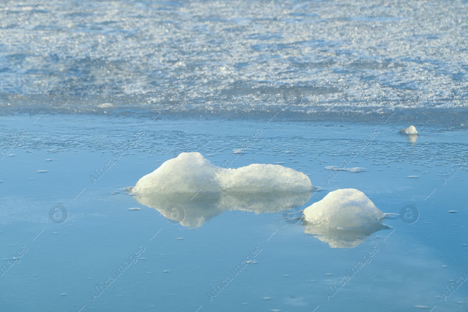 Photo of Melting ice in river water on sunny day. Early spring