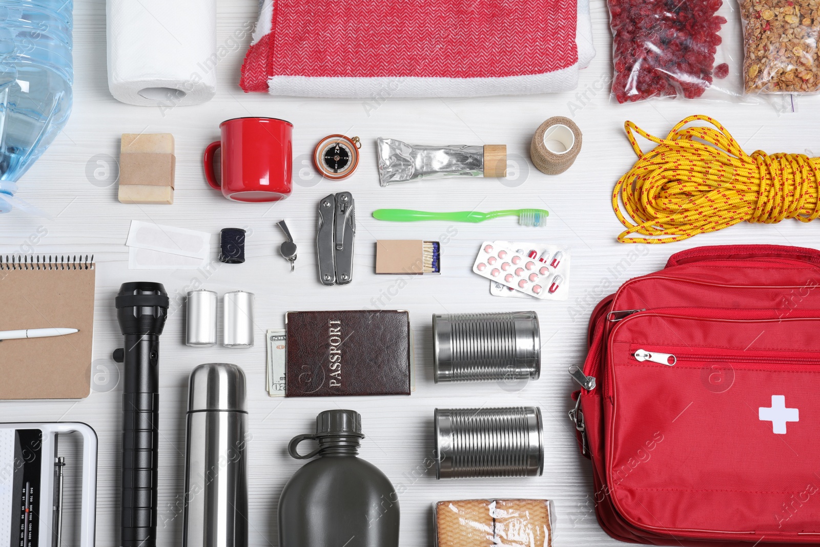 Photo of Disaster supply kit for earthquake on white wooden table, flat lay