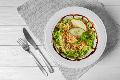 Photo of Plate with delicious fresh salad on table, top view