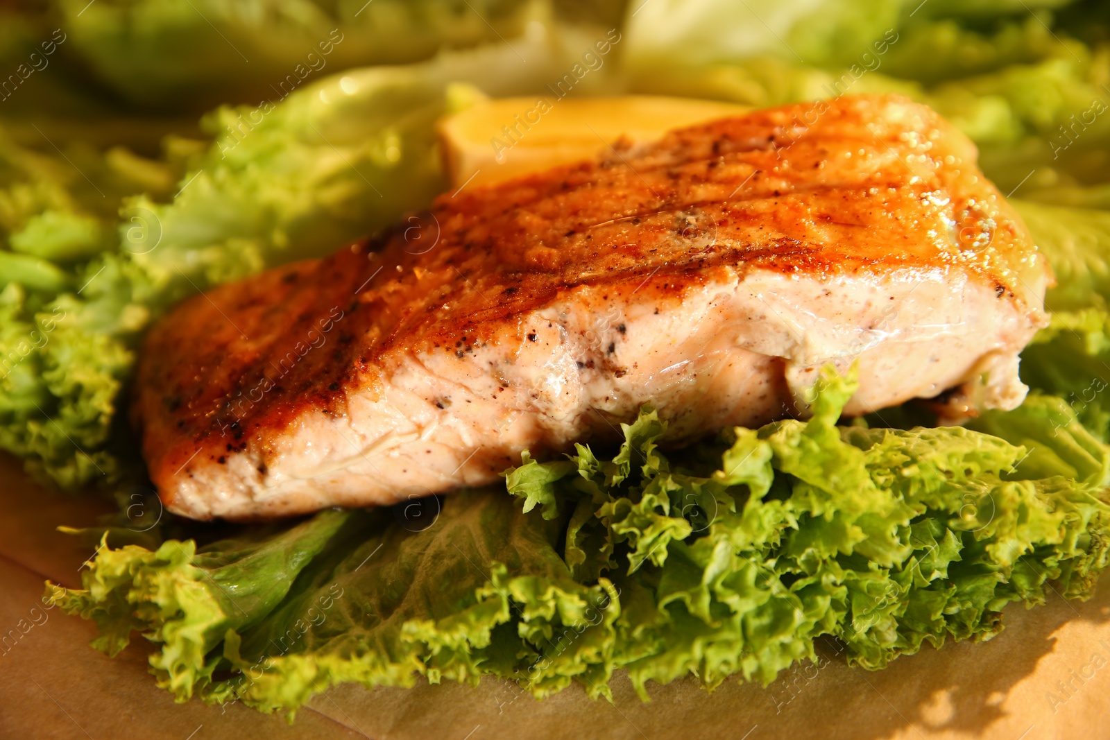 Photo of Tasty freshly cooked salmon served on table, closeup