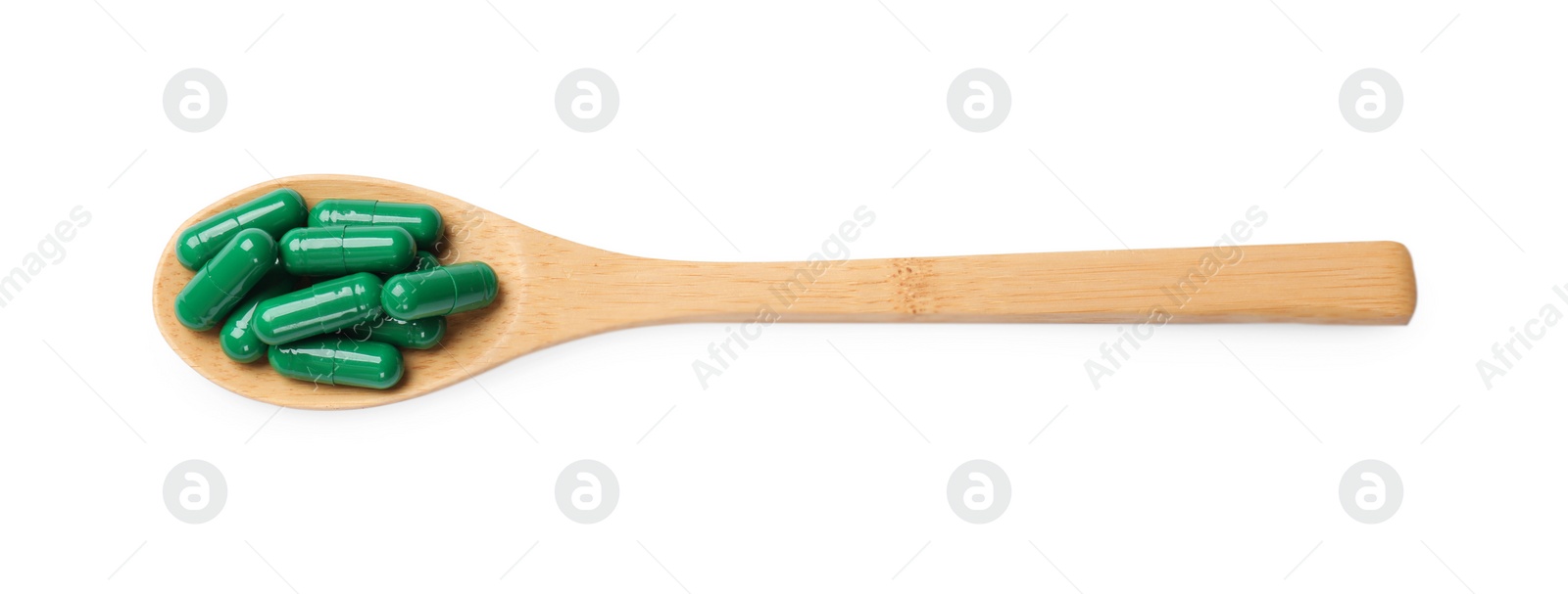 Photo of Vitamin capsules in wooden spoon isolated on white, top view