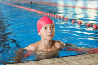 Photo of Cute little boy in indoor swimming pool