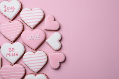 Photo of Delicious heart shaped cookies on pink background, flat lay. Space for text
